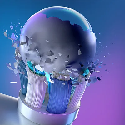 Oral-B opzetborstel met een bol die in stukken breekt, wat de kracht en effectiviteit van de reiniging symboliseert.