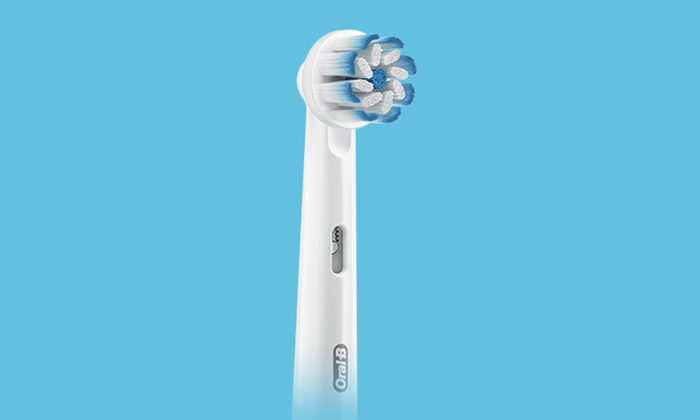 Oral-B iO Gentle Care opzetborstel met zachte borstelharen op blauwe achtergrond.